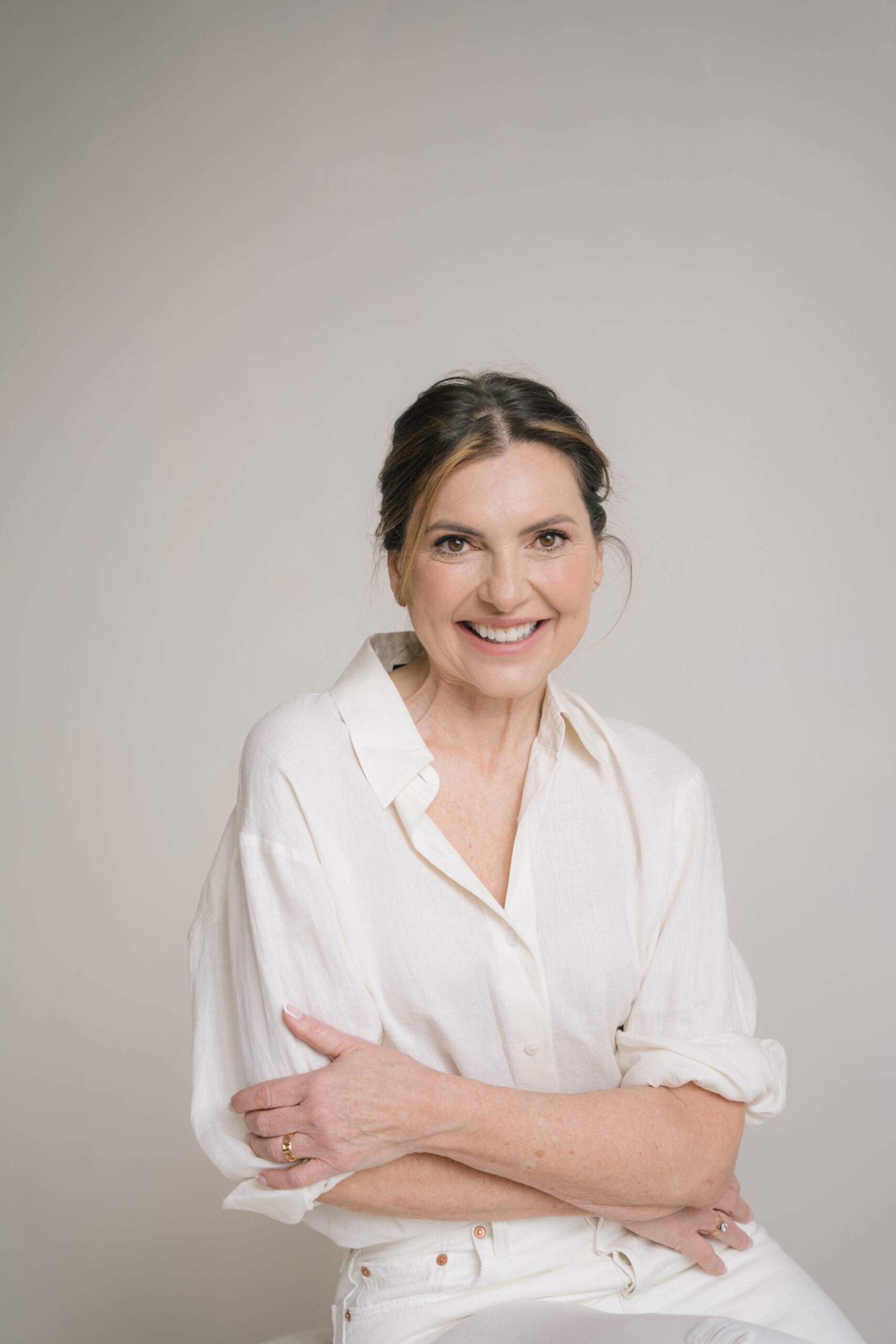 Jonge vrouw met bril die kijkt in de camera en lacht